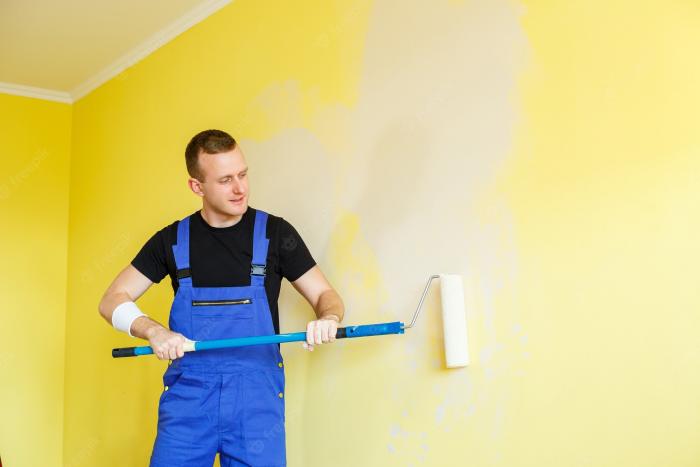 young-man-makes-repairs-apartment-ok-re-paints-walls-different-color_173815-10884