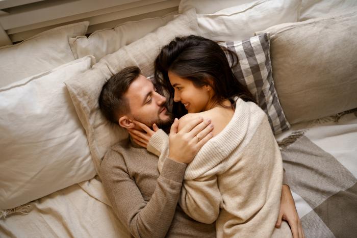 beautiful-young-happy-couple-relaxing-in-bed-and-smiling-embracing