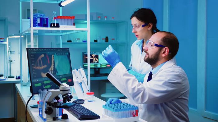 chemist-nurse-holding-test-tubes-bringing-to-doctor-conducting-dna-experiment-discussing-about-medical-treatment-working-overtime
