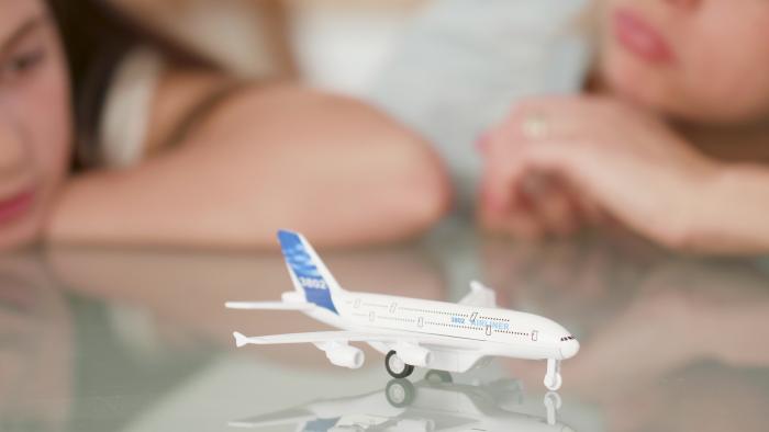 closeup-of-mother-and-daughter-looking-at-toy-plane-dreaming-at-nature-holiday-during-coronavirus-quarantine-family-imaginating-dream-adventure-concept-of-outdoor-vacations-summer-vacation