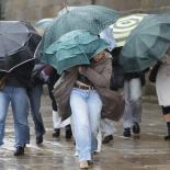 Varias personas se protegen de la lluvia