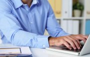 Cropped image of businessman working on laptop