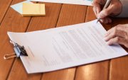 Close-up image of entrepreneur checking document before signing