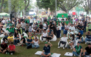 La cancha de césped natural se transformó en un estadio al aire libre, con una tarima principal y carpas dispuestas frente a tres pantallas gigantes digitales