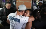 Personas se abrazan durante un velorio por las víctimas mortales de la explosión de un cilindro bomba en Cajibío (Colombia).