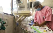Un integrante del personal hospitalario da de comer a un bebé conectado a una cánula de oxígeno el 21 de mayo de 2026, en un hospital en La Paz (Bolivia).