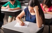 Group of high school students taking a test in a classroom