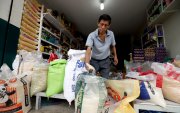 Un comerciante muestra que el arroz de grano largo es de mejor calidad y que la libra cuesta 0,50 dólares.