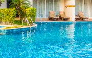 Empty Umbrella and chair around swimming pool in hotel resort