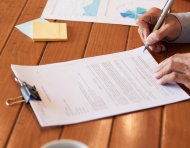 Close-up image of entrepreneur checking document before signing
