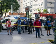 Personas observan las labores de rescate y remoción de escombros tras los terremotos en Chacao, Caracas.