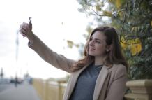 young-woman-in-coat-taking-selfie-with-smartphone-on-street-3776445