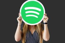 woman-holding-up-spotify-icon-isolated (1)