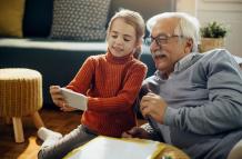 happy-little-girl-and-her-grandfather-taking-selfie-at-home