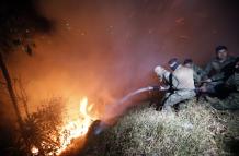 Personal de las Fuerzas Armadas trabaja para sofocar un incendio.