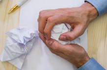 hands-business-executive-making-paper-ball