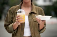 front-view-woman-holding-soda