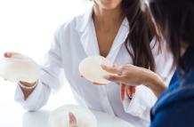 doctor-her-patient-choosing-mammary-prosthesis-office
