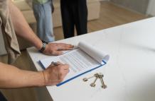 side-view-buyer-signing-document