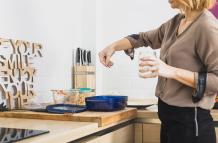 female-standing-kitchen-salting-food