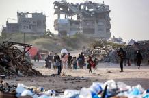Personas desplazadas por el conflicto y que huyen de Beit Hanún, en el norte de la Franja de Gaza, llegan cargando sus pertenencias a la Ciudad de Gaza el 18 de marzo de 2025.