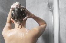 young-woman-applying-anti-dandruff-product