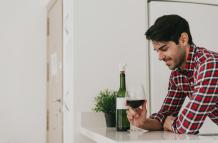 cheerful-man-having-wine-home