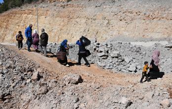 People walk at Masnaa