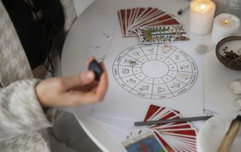high-angle-woman-reading-tarot-home