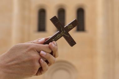 woman-holding-crucifix-church