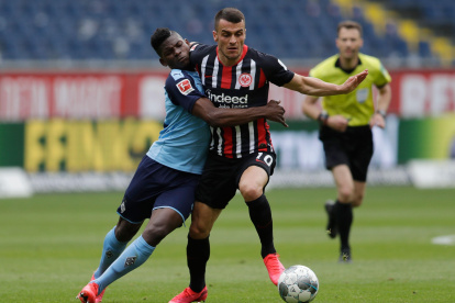 Breel Embolo (i) disputa el balón con Filip Kostic. Acciones como estas son normales en el fútbol, sin embargo, se prohiben los abrazos en las celebraciones.