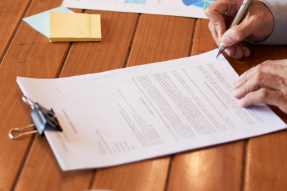 Close-up image of entrepreneur checking document before signing