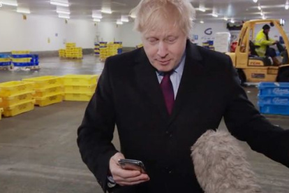 LONDRES. El primer ministro británico, Boris Johnson, cuando retiene el celular