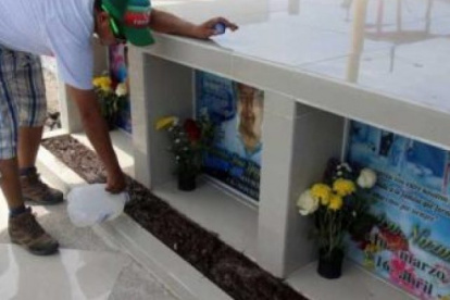 Jaime Macías señala el nombre de su madre en el memorial ubicado en el centro de Tarqui, Manta.