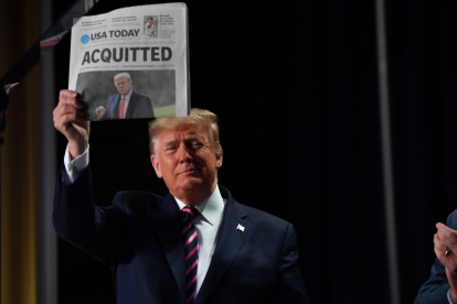 US President Donald Trump holds up a newspaper that displays a headline "Aquitted"  as he arrives to speak at the 68th annual National Prayer Breakfast on February 6, 2020 in Washington,DC. President Donald Trump said Thursday that he suffered a "terrible ordeal" during his impeachment. In his first public comments since being acquitted by the Senate of abuse of office, he said he had been "put through a terrible ordeal by some very dishonest and corrupt people." "They have done everything possible to destroy us and by so doing very badly hurt our nation," he said at a televised prayer breakfast with a Who"s Who of Washington power brokers.
 / AFP / Nicholas Kamm

 US-POLITICS-PRAYER-TRUMP