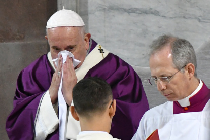 Pope Francis blows his nose as he leads the Ash Wednesday mass which opens Lent, the forty-day period of abstinence and deprivation for Christians before Holy Week and Easter, on February 26, 2020, at the Santa Sabina church in Rome. (Photo by Alberto PIZZOLI / AFP)