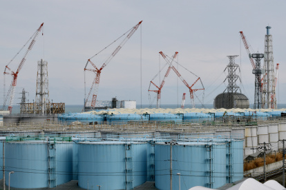This picture taken on February 3, 2020 shows (from L) units one to three reactor buildings and storage tanks for contaminated water at the Tokyo Electric Power Company"s (TEPCO) Fukushima Daiichi nuclear power plant in Okuma, Fukushima prefecture. - Nine years after the disaster at the Fukushima Daiichi nuclear plant sparked by a devastating tsunami, clean-up and decommissioning continues at the crippled facility. (Photo by Kazuhiro NOGI / AFP)