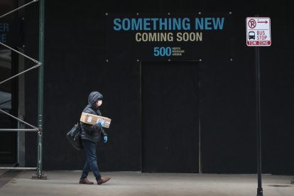 CHICAGO, ILLINOIS - MARCH 27: A pedestrian walks along a nearly-deserted Michigan Avenue on March 27, 2020 in Chicago, Illinois. Nearly all of the stores along this stretch of Michigan Avenue known as the Magnificent Mile have been closed since the governor issued a stay-at-home order in an attempt to curtail the spread of the coronavirus COVID-19 in the city.   Scott Olson/Getty Images/AFP

== FOR NEWSPAPERS, INTERNET, TELCOS & TELEVISION USE ONLY ==

 US-CORONAVIRUS-PANDEMIC-CAUSES-CLIMATE-OF-ANXIETY-AND-CHANGING-R