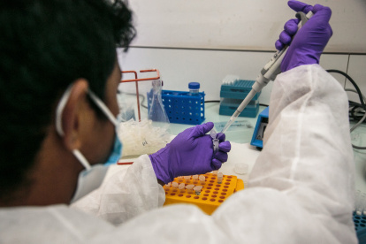 Institut Pasteur laboratory workers perform PCR (Polymerase Chain Reaction) tests to determine whether patients are positive for the new COVID-19 coronavirus, in Antananarivo, April 23, 2020. - Since March 18, 2020, Institut Pasteur has tested 2300 patients for the COVID-19 coronavirus. Each test requires 4 hours of processing time. To date, 121 patients have been tested positive for COVID-19, including 58 patients who have been cured. (Photo by RIJASOLO / AFP)