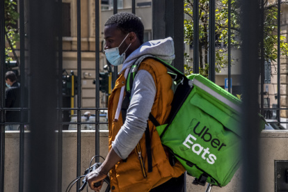 A delivery man exits with his bicycle the San Giovani underground metro station during a test phase in Rome, on April 27, 2020, during the country"s lockdown aimed at curbing the spread of the COVID-19 infection, caused by the novel coronavirus. - First tests were under way for subway access with security measures to avoid coronavirus infection in "Phase 2", that will re-open on May 4. (Photo by Tiziana FABI / AFP)