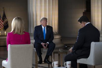 US President Donald Trump gestures as he speaks during a Fox News virtual town hall "America Together: Returning to Work," event, with anchors Bret Baier (R) and Martha MacCallum (L), from the Lincoln Memorial in Washington, DC on May 3, 2020. - Trump will answer questions submitted by viewers on Twitter, Facebook and Instagram. (Photo by JIM WATSON / AFP)