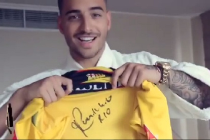 Maluma muestra una camiseta de Barcelona firmada por Ronaldinho.