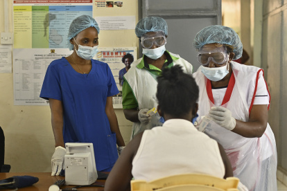 Volunteer nurse, Anita Thumbi (L), who is also an elected Member of County Assembly (MCA) in the Nairobi County Government, tends to patients with other nursing staff at a facility used to train the public on infection prevention and management at a local health centre in Waithaka, a Nairobi suburb on May 12, 2020, on International Nurses Day. - Anita Thumbi, a nurse by training, chose to forego the lofty perch of elective office opting to return to her grassroots as a volunteer nurse to join the frontlines in the fight against the COVID-19 coronavirus after the discovery of the first case of infection within Kenya two-months ago at a time of apprehension about Kenya"s ability to cope with the rapidly spreading pandemic. (Photo by TONY KARUMBA / AFP)