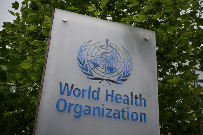 (FILES) In this file photo taken on May 12, 2020 shows a sign of the World Health Organization (WHO) in Geneva next to their headquarters, amid the COVID-19 outbreak, caused by the novel coronavirus. - President Donald Trump said May 29, 2020, he was breaking off US ties with the World Health Organization, which he says failed to do enough to combat the initial spread of the novel coronavirus. (Photo by Fabrice COFFRINI / AFP)