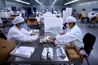 Workers package rabies vaccine at a lab at the Yisheng Biopharma company, where researchers are trying to develop a vaccine for the COVID-19 coronavirus, in Shenyang, in China"s northeast Liaoning province, on June 9, 2020. 
 China has mobilised its army and fast-tracked tests in the global race to find a coronavirus vaccine, and is involved in several of the dozen or so international clinical trials currently under way.  / AFP / NOEL CELIS

 CHINA-HEALTH-VIRUS