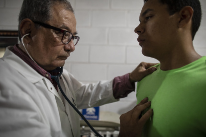 Gustavo Méndez revisa a un paciente en su casa, tras su salida del hospital Manuel de Jesús Rivera.