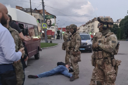 LUTSK. Las fuerzas de seguridad detienen al presunto secuestrador (tirado en el suelo) luego de la liberación de rehenes de un autobús secuestrado en el centro de la ciudad ucraniana.