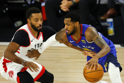 Monte Morris (11), de los Denver Nuggets, frente a Norman Powell, de los Raptors de Toronto.