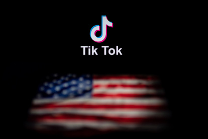 (FILES) In this file photo illustration taken on September 14, 2020, shows the logo of the social network application TikTok and a US flag on the screens of two laptops in Beijing. - US officials on September 18, 2020, ordered a ban on downloads of the popular Chinese-owned mobile applications WeChat and TikTok from September 20, saying they threaten national security. The move comes amid rising US-China tensions over technology and a Trump administration effort to engineer a sale of the video app TikTok to American investors. (Photo by NICOLAS ASFOURI / AFP)