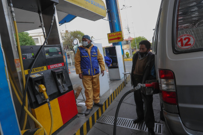 Empleados atienden en un surtidor de gasolina hoy en La Paz (Bolivia).